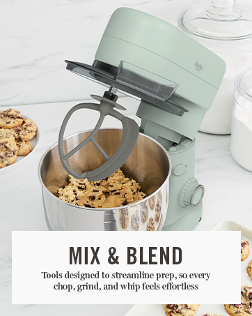 stand mixer with cookie dough inside, head tilted