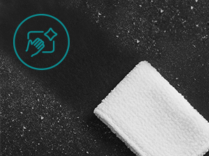 White rectangular object against a dark starry or speckled background with a teal circular icon visible.