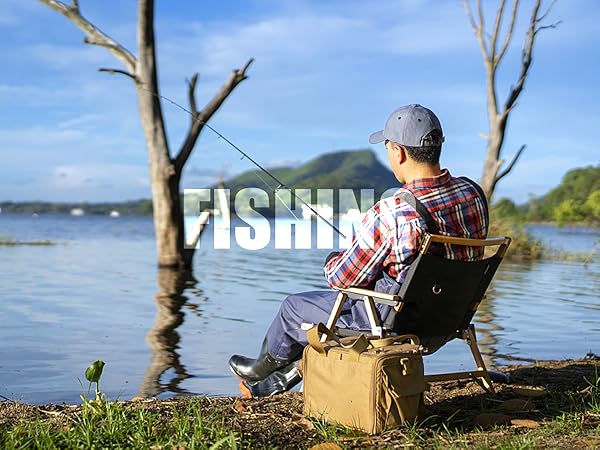 Person in plaid shirt fishing from a folding chair by a lake, with dead trees in water and 'FISHING' text overlay.