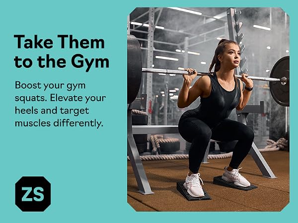Woman doing barbell squats on slant board calf stretcher and squat wedge block at the gym