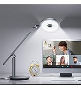 LED desk lamp with adjustable arm positioned on desk with monitor showing video conference, demonstrating lighting for remote meetings.