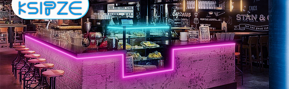 a counter with food on it and a neon sign above it.