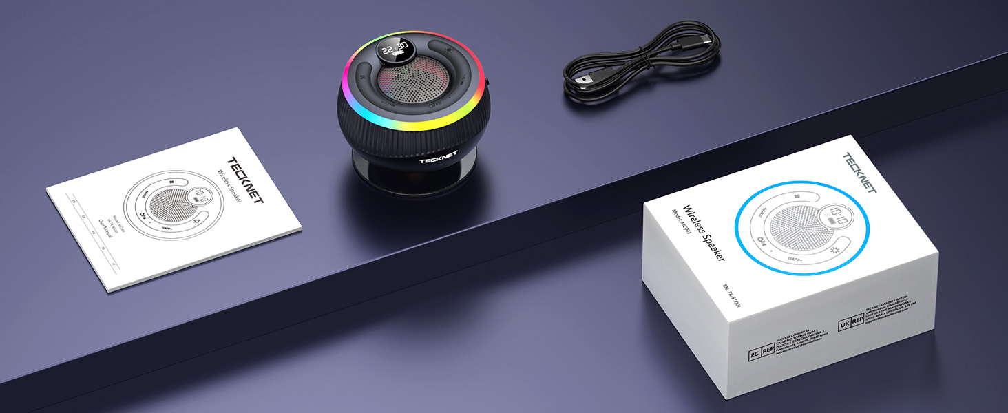 Product photography setup showing wireless charger and white product boxes against dark background with professional lighting.