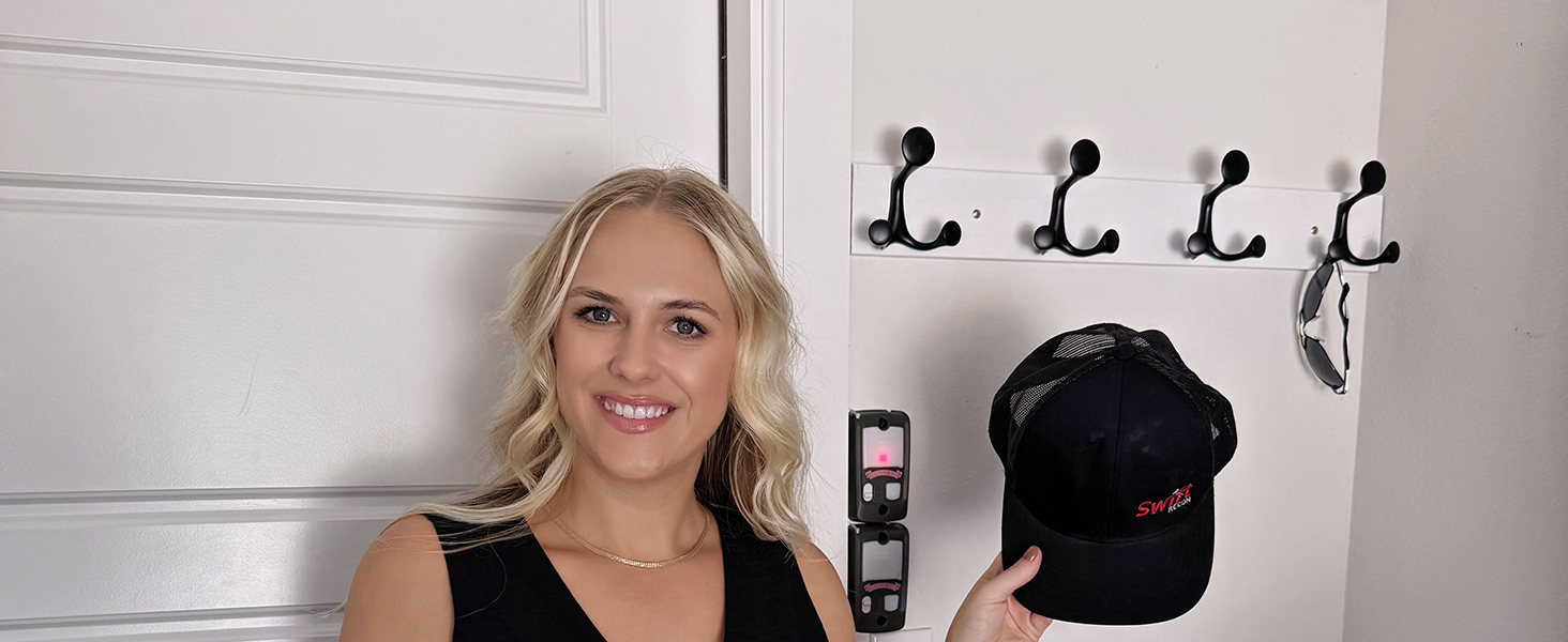 A lady is very happy that this coat rack provides convenience at the entrance for hanging hats.