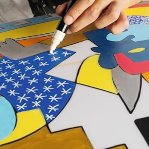 drawing stars with a white posca marker