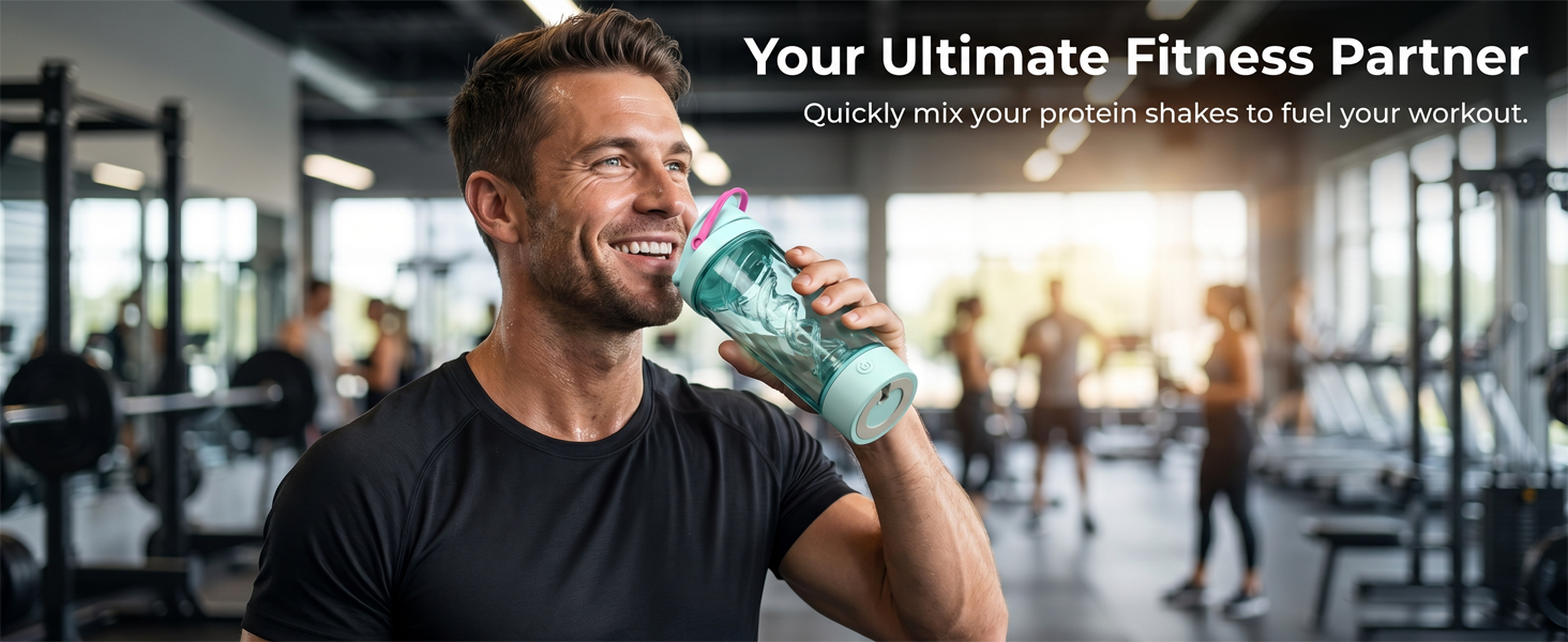 Man drinking from electric shaker bottle in gym after mixing a protein shake.