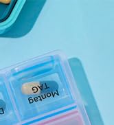 Partial view of a light blue plastic container with compartments. Text on the container reads 'DYE' or 'DYE Employ'.