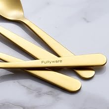 Set of gold-colored flatware on marble surface. Four pieces visible, including spoons and knife, with sleek, modern design and 'Fullyware' engraved on handle.