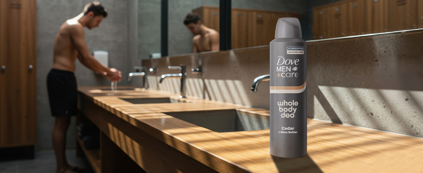 Man using sink in locker room; Dove Men+Care deodorant on counter