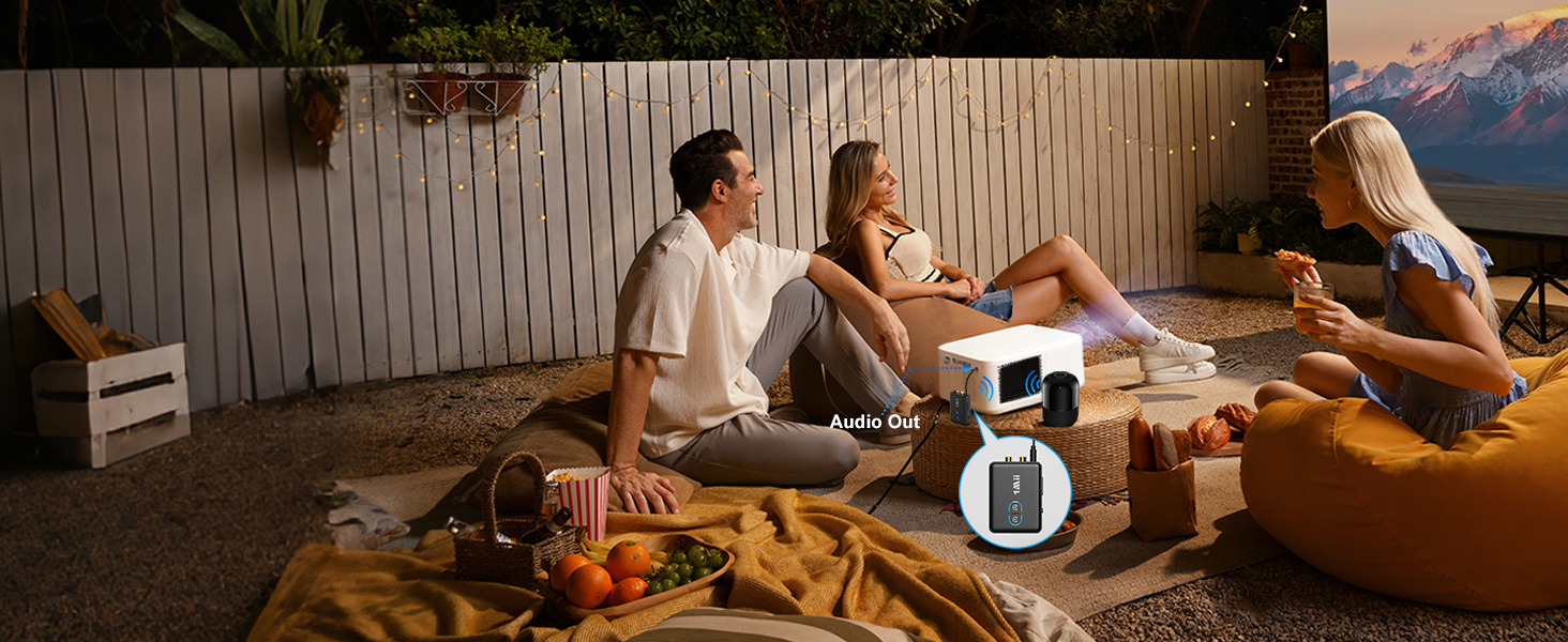 Indoor setting showing people relaxing on furniture, with warm ambient lighting creating a cozy atmosphere.