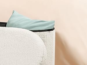 Close-up of a light blue slip-on shoe resting on a white textured surface, showcasing its minimalist design and comfortable appearance.