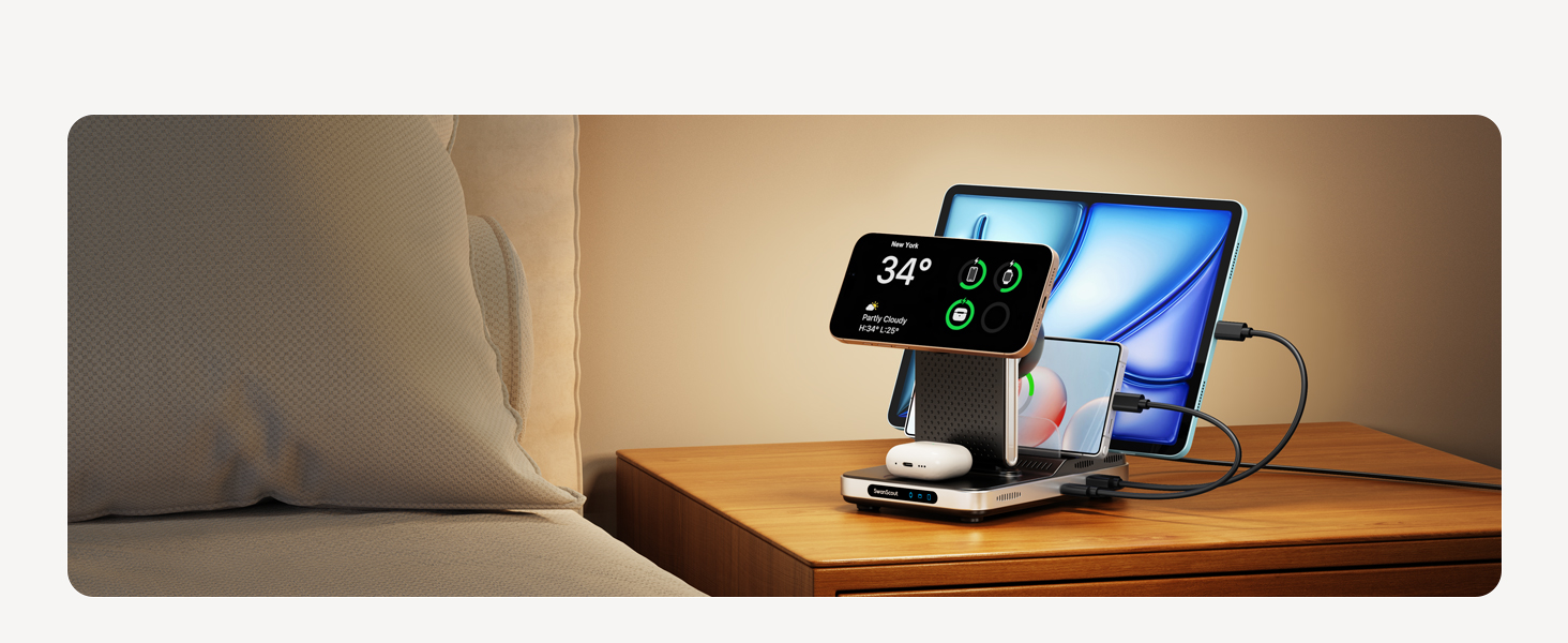 Charging stand on wooden surface holding smartphone and tablet. Stand features wireless charging pad and USB ports for multiple device connectivity.