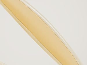 Transparent yellow plastic folding ruler or measuring tool against white background.