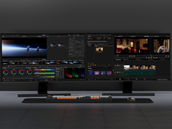 Wide curved monitor displaying multi-panel video editing interface with timelines, color correction tools, and preview windows. Keyboard and editing console visible below.