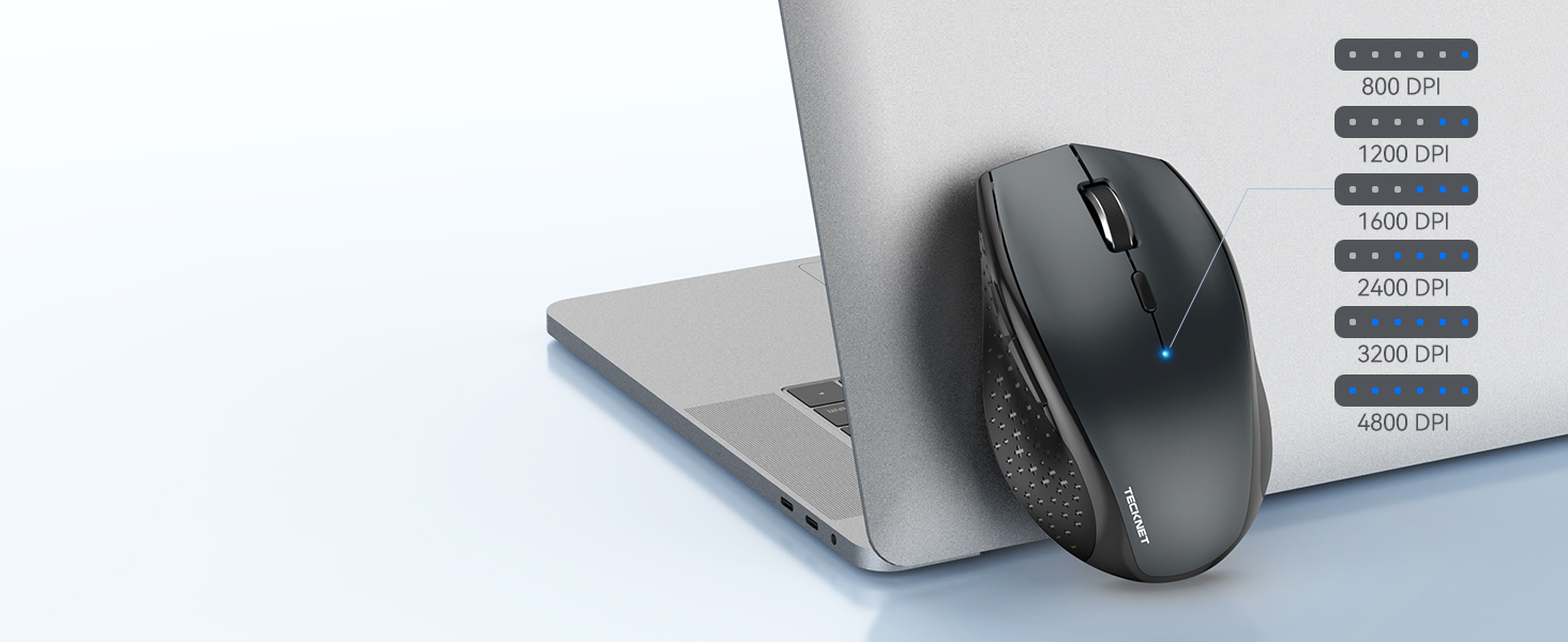 Wireless computer mouse next to specification chart showing DPI settings, displayed against grey surface.