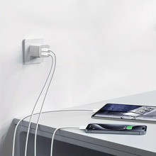 A tablet and a phone charging on a table with 2 port charging block and both USB-C cables