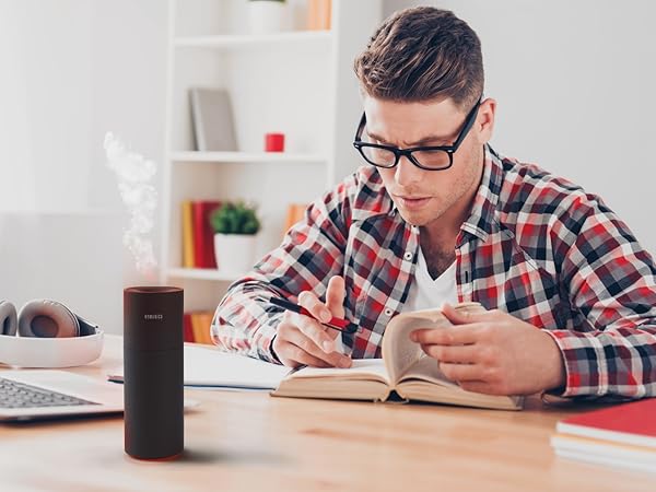 black portable air purifier sitting on desk