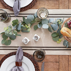 A table set with a DII French Stripe table runner and napkin set in red