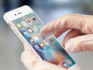 CarePlus vinyl gloves with touchscreen compatibility for phones, tablets, and devices