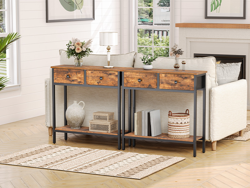 Rustic console table with four drawers and two shelves. Wood top with metal frame. Placed behind a white couch in a living room setting.