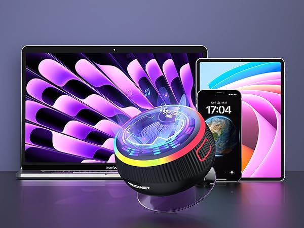 Product display showing circular cooling fan device with purple LED lighting effects, positioned between a laptop and smartphone against dark background.