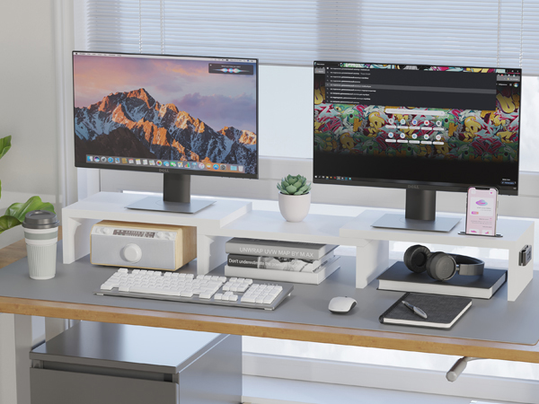 a desk with two monitors and a laptop