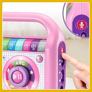 Kid pushes record button on music player to record voice.