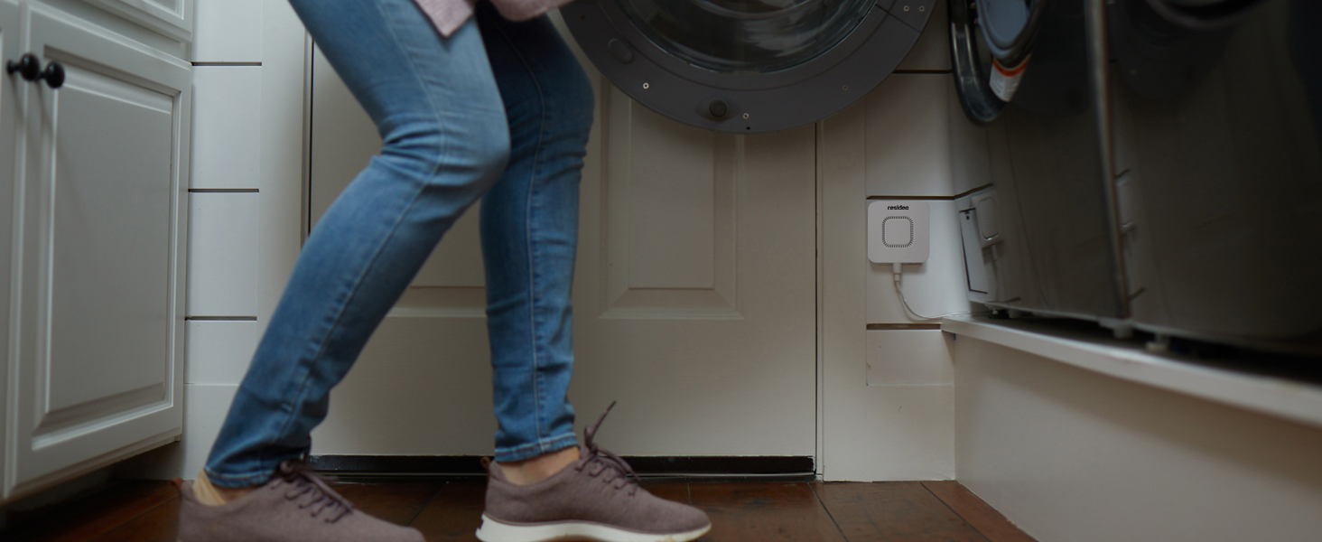RWD42 Water Leak Detector mounted on wall next to washing machine