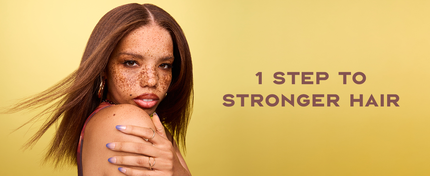 Image of a black woman with freckles &amp;amp; straight hair next to text: &amp;#34;1 step to stronger hair&amp;#34;.