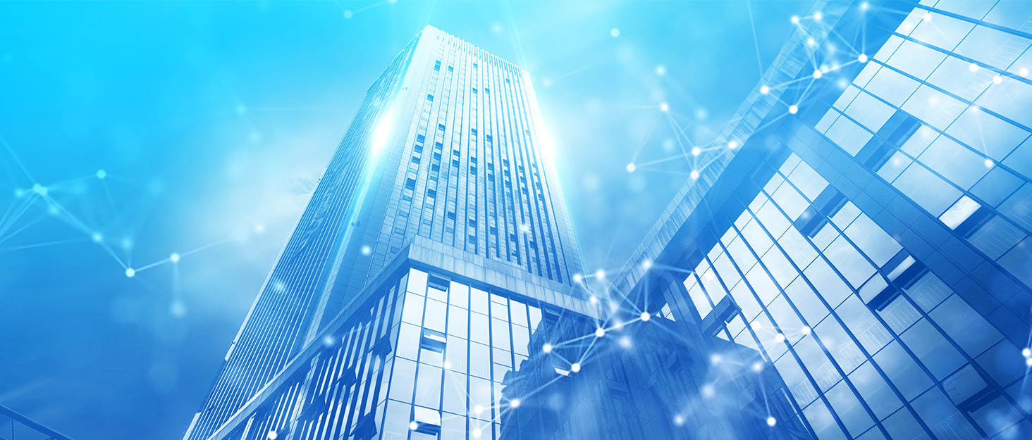 Low-angle view of a tall skyscraper with reflective glass exterior, illuminated against a blue sky with digital network overlay.