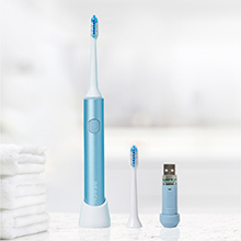 Power toothbrush on bathroom counter with USB charger