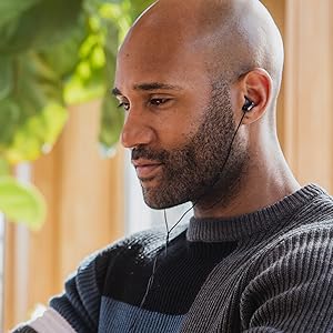 african american man listening to music wearing corded black earbuds