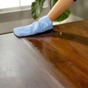 A hand in a microfiber mitt applying Rejuvenate Cabinet &amp; Furniture Cleaner