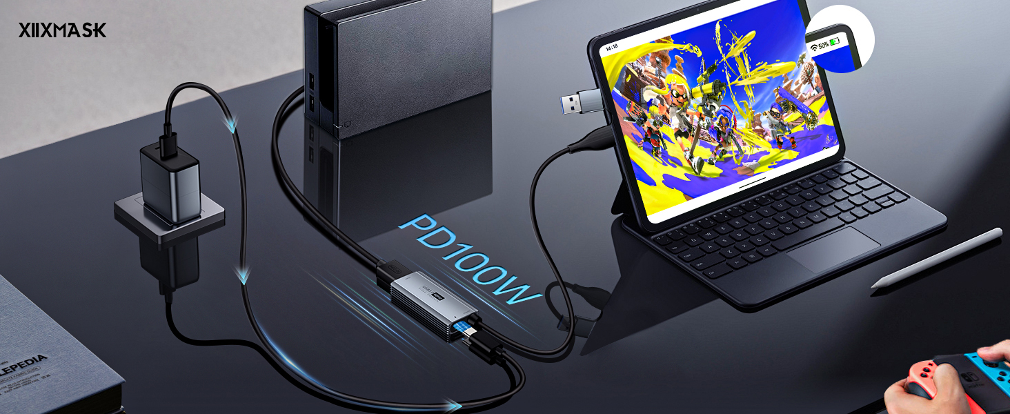 Laptop-style device with detachable keyboard connected to power bank. Charging cable links power bank to wall adapter. Vibrant cartoon displayed on device screen.