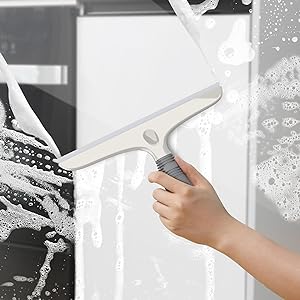 a hand holding a window cleaner with a white background