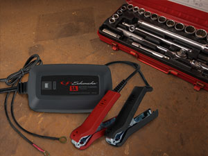 Car battery charger features quick-connect harness to quickly switch between two connectors.