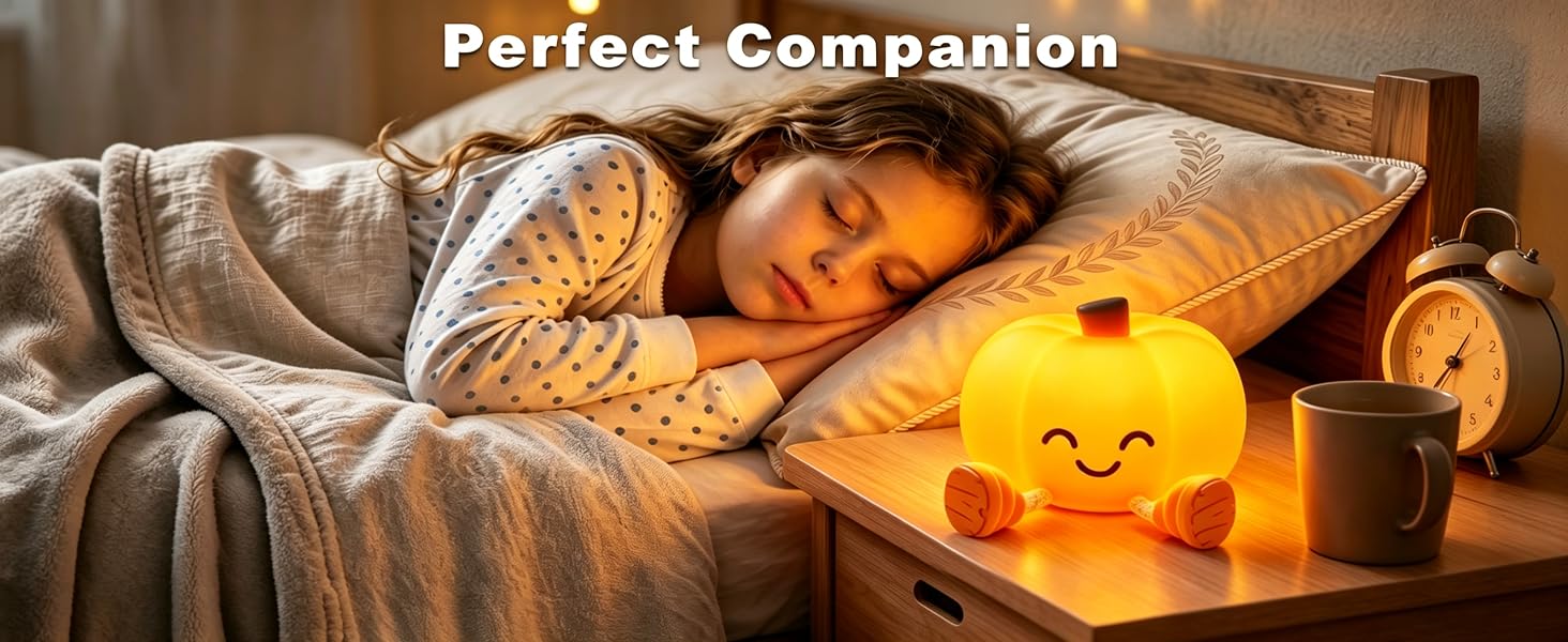 A pumpkin nightlight on the nightstand