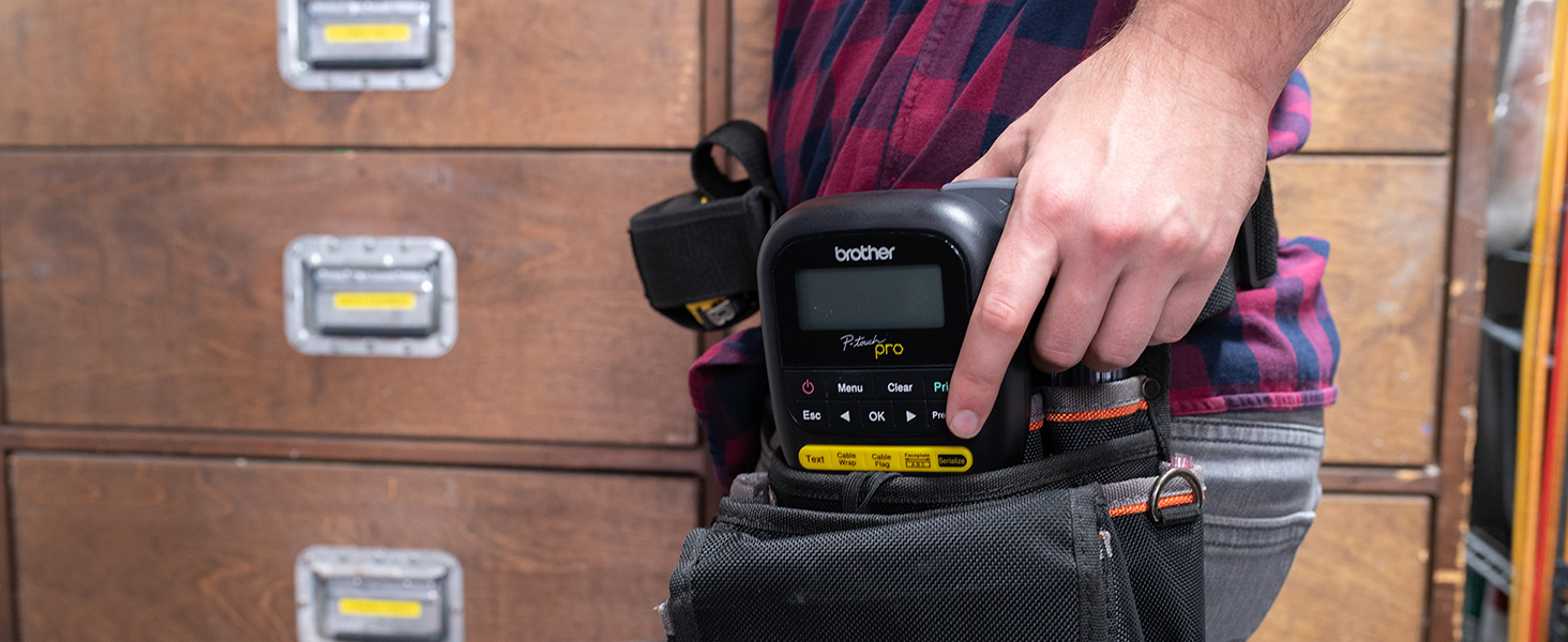 Person holding PTH111 P-touch Pro Label Maker in tool belt