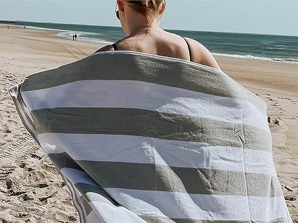 Woman with a beach towel wrapped behind her