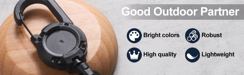 Black carabiner-style clip with circular attachment point on wooden surface. Text highlights features: bright colors, robust, high quality, and lightweight.