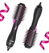 Two black hot air styling brushes with pink accents, featuring round bristled barrels. Decorative pink ribbon element in composition.