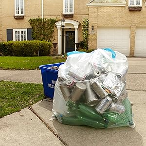 A full clear recycling bag sitting on the curb