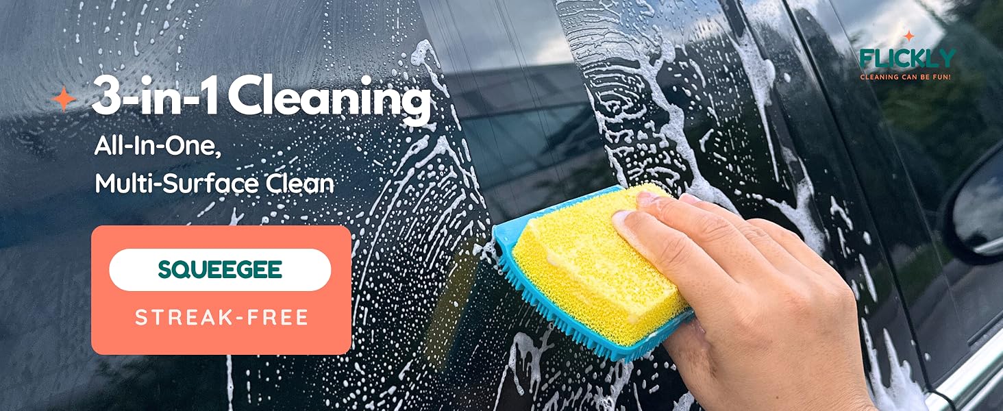Hand using a sponge with squeegee edge to clean a soapy car window, demonstrating streak-free finish