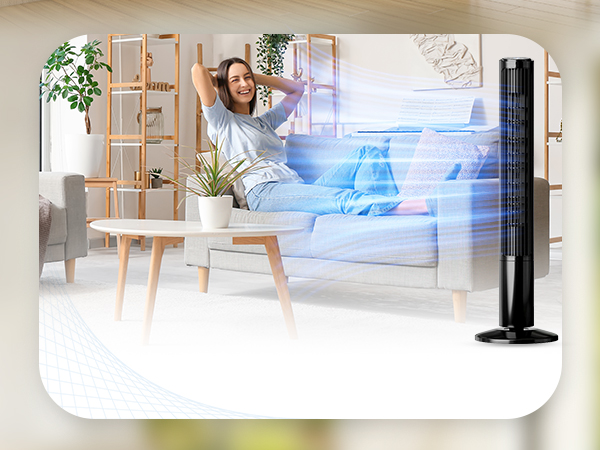 Woman sitting on the couch injoying the fan breeze