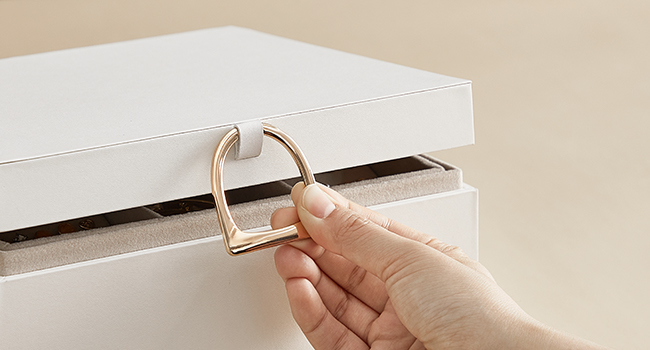 a hand opening a drawer with a ring