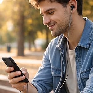 Betron B25 wired earphones connected to smartphone, lifestyle listening outdoors