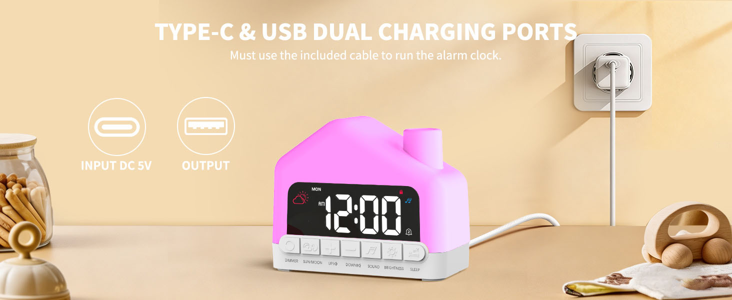 Text reads: 'TYPE-C &amp; USB DUAL CHARGING PORTS'. Pink digital alarm clock with LCD display showing '12:00', connected to dual charging port outlet on beige background with decorative items.