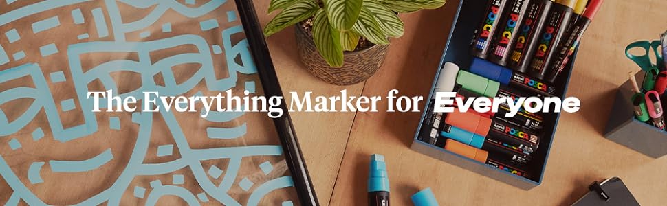 posca markers on desk with other art supplies
