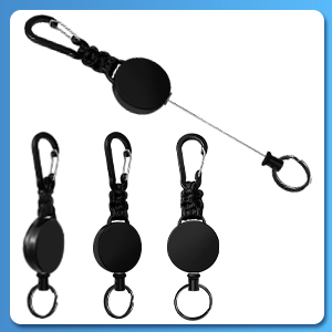 Retractable key chain set with carabiner clips. Four black circular devices, one extended to show wire mechanism for attaching keys or small items.