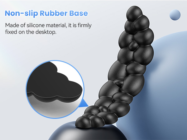 Black silicone object with bubble-like segments forming a curved shape. Non-slip rubber base shown in magnified inset. Text describes silicone material and desktop fixation.
